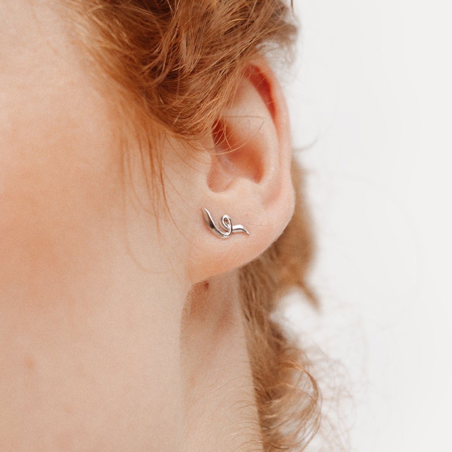 Poise Twirl Stud Earrings, recycled Sterling Silver, shown on ear - VEYIA Berlin