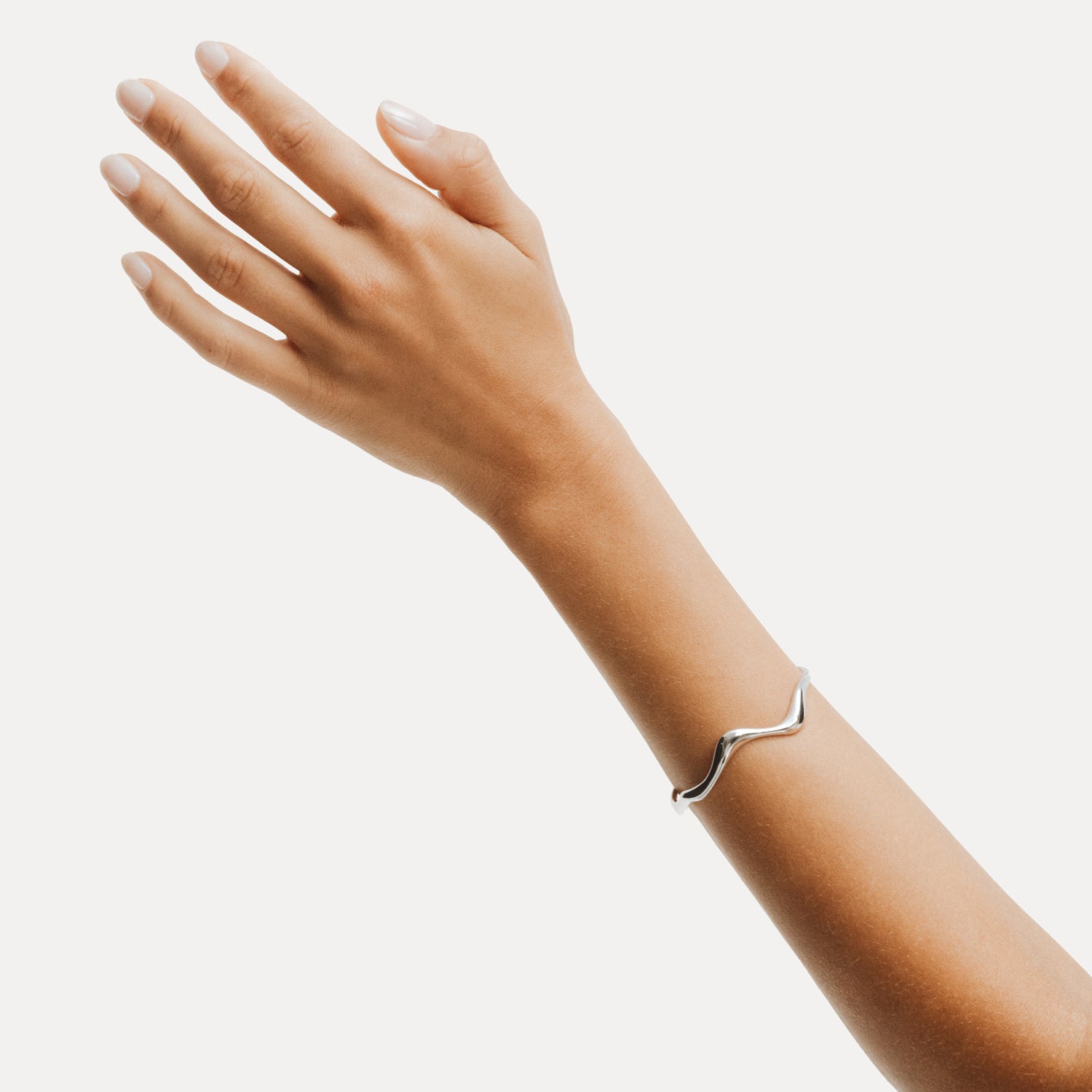 Poise Wave Cuff Bangle, recycled Sterling Silver, shown on hand - VEYIA Berlin