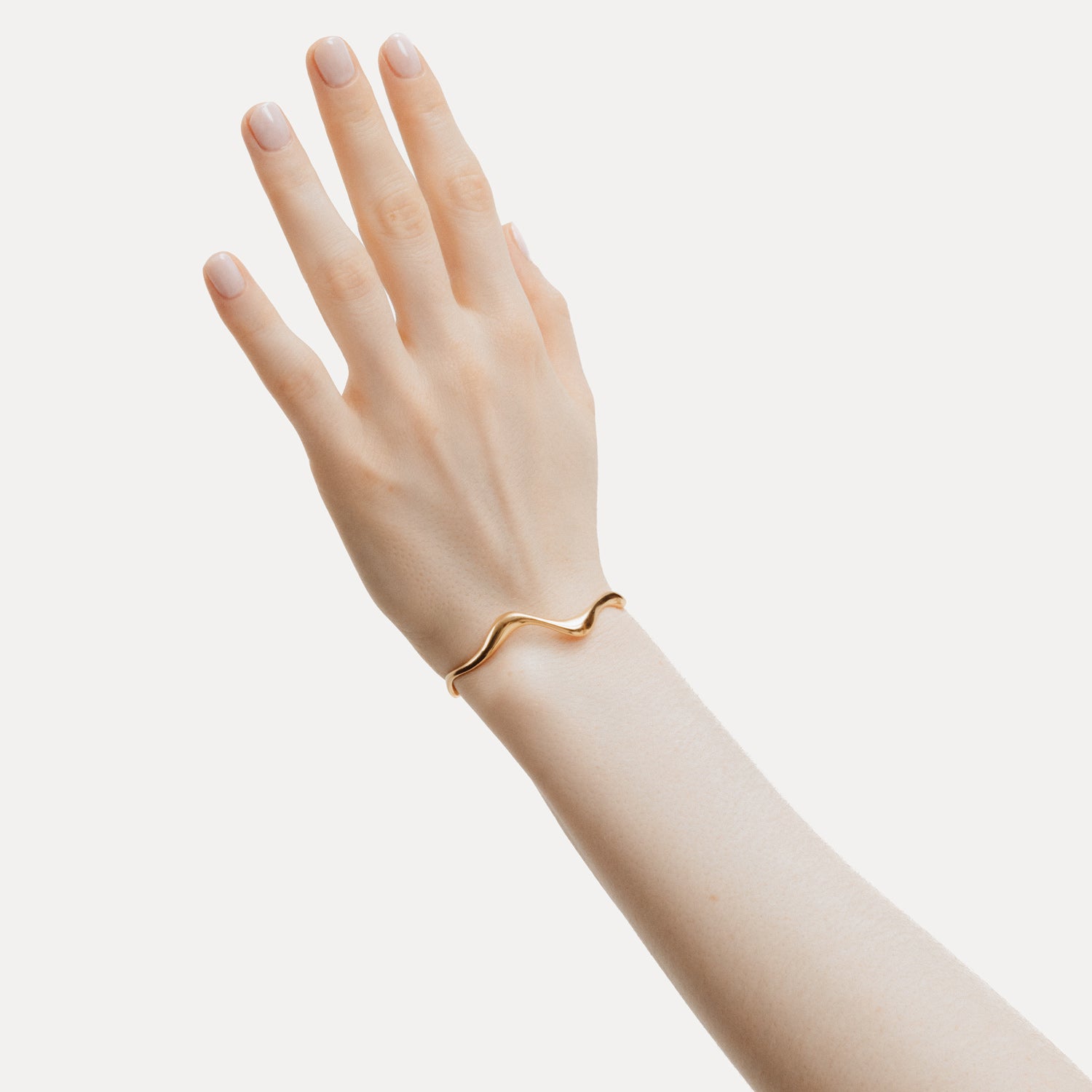 Poise Wave Cuff Bangle, recycled 18k Gold Vermeil, shown on hand - VEYIA Berlin